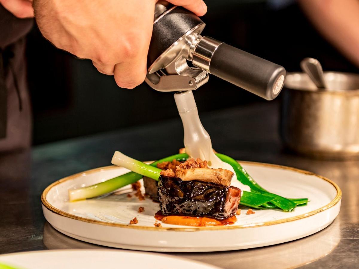 Dakota Leeds Hotel Leeds  Bagian luar foto A chef plating a dish